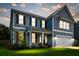 Charming two-story blue home with a well-manicured lawn, white trim, and an attached garage at 256 Fiddleback Dr, Summerville, SC 29486