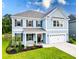 Charming two-story home with blue siding, shutters, a well-kept lawn, and an attached garage at 256 Fiddleback Dr, Summerville, SC 29486