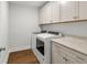 Well-lit laundry room with cabinetry, folding counter, and modern washer and dryer set at 256 Fiddleback Dr, Summerville, SC 29486