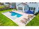 Aerial view of backyard pool with lounge chairs and manicured lawn at 256 Fiddleback Dr, Summerville, SC 29486