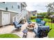 Well-manicured backyard with an outdoor kitchen, dining area, and cozy seating around a fire pit at 2734 Battle Trail Dr, Johns Island, SC 29455