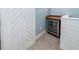 Convenient bar area with a beverage cooler and tiled countertop, next to a sliding barn door at 2734 Battle Trail Dr, Johns Island, SC 29455