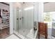 Glass enclosed shower featuring tiled walls, gray tiled flooring and built in shelf at 2734 Battle Trail Dr, Johns Island, SC 29455