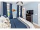Bright bedroom with large bed, window view, guitar wall decor, and blue accents at 2734 Battle Trail Dr, Johns Island, SC 29455