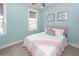 Bright bedroom with light blue walls, carpet flooring, and comfortable bed with plush pillows at 2734 Battle Trail Dr, Johns Island, SC 29455