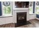 Fireplace with built-in shelves and cabinets on either side and windows with built-in seats at 2734 Battle Trail Dr, Johns Island, SC 29455