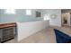 Bright hallway with white wainscoting, a drink refrigerator, and coastal decor elements at 2734 Battle Trail Dr, Johns Island, SC 29455
