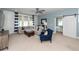 Bright living room with a large sectional sofa, barn door, accent chair, and a ceiling fan at 2734 Battle Trail Dr, Johns Island, SC 29455