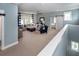 Spacious living room with comfortable seating, neutral carpet, and a barn door leading to the bedroom at 2734 Battle Trail Dr, Johns Island, SC 29455