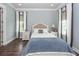 Bright main bedroom featuring hardwood floors, a comfortable king bed, and large windows for natural light at 2734 Battle Trail Dr, Johns Island, SC 29455