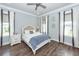 Serene main bedroom with neutral tones, hardwood floors, and ample natural light streaming through the windows at 2734 Battle Trail Dr, Johns Island, SC 29455