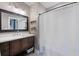 Bathroom featuring dark wood vanity, stone countertop, decorative shelves and shower with curtain at 2924 Alabama Dr, North Charleston, SC 29405