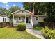 Charming home featuring a covered porch, freshly painted siding, manicured lawn and a quaint American flag at 2924 Alabama Dr, North Charleston, SC 29405