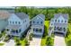 Stunning aerial view of coastal homes featuring inviting front porches and lush landscaping in a vibrant neighborhood at 3016 Evening Tide Dr, Hanahan, SC 29410