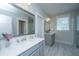 Stylish bathroom with double vanities, a large mirror, and a walk-in glass shower, offering a spa-like experience at 3016 Evening Tide Dr, Hanahan, SC 29410