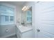 Well-lit bathroom featuring a bright vanity, a large mirror, and a window providing natural light at 3016 Evening Tide Dr, Hanahan, SC 29410