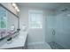 Modern bathroom features a glass-enclosed shower with herringbone tile and a vanity with sleek countertop at 3016 Evening Tide Dr, Hanahan, SC 29410