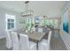 Open-concept dining room with modern lighting and connection to the living room at 3016 Evening Tide Dr, Hanahan, SC 29410