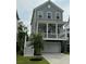 Charming two-story home with a covered porch, gray siding, white trim and a two car garage at 3016 Evening Tide Dr, Hanahan, SC 29410