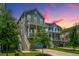 Charming two-story home with a covered porch and manicured lawn at dusk at 3016 Evening Tide Dr, Hanahan, SC 29410