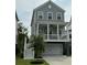 Charming two-story home with a covered porch, gray siding, white trim and a two car garage at 3016 Evening Tide Dr, Hanahan, SC 29410