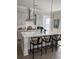 Modern kitchen with a large island, white cabinets, stylish pendants, and sleek countertops at 3016 Evening Tide Dr, Hanahan, SC 29410
