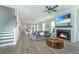 Spacious living room with a fireplace, open to dining area, and hardwood floors at 3016 Evening Tide Dr, Hanahan, SC 29410