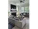 Bright living room with modern fireplace, ceiling fan, hardwood floors and comfortable couches at 3016 Evening Tide Dr, Hanahan, SC 29410
