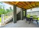 Covered outdoor patio with a dining table, ideal for al fresco dining and relaxation, near stairs and greenery at 3016 Evening Tide Dr, Hanahan, SC 29410