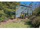 Backyard with a lush lawn, quaint patio, and a charming blue two-story house surrounded by natural beauty at 3306 Hartwell St, Johns Island, SC 29455