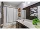 Modern bathroom featuring dark vanity with white countertops and decorative mirror and neutral colors at 3306 Hartwell St, Johns Island, SC 29455