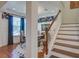 Bright dining room featuring blue accent wallpaper, dining table, and natural light, adjacent to staircase at 3306 Hartwell St, Johns Island, SC 29455