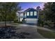 Charming blue two-story home at twilight with a spacious driveway and welcoming double porch at 3306 Hartwell St, Johns Island, SC 29455