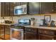 Updated kitchen featuring stainless steel appliances, granite countertops, and dark wood cabinetry at 3306 Hartwell St, Johns Island, SC 29455