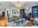 Cozy living room with leather sofas, hardwood floors, and built-in display cabinets, bathed in soft light at 3306 Hartwell St, Johns Island, SC 29455