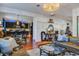 Open-concept living room showcasing a leather sofa, glass coffee table, and view into the modern kitchen at 3306 Hartwell St, Johns Island, SC 29455