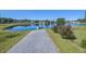 Scenic pond view with lush green grass, a walking path, and peaceful houses in the background at 3306 Hartwell St, Johns Island, SC 29455