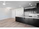 Modern kitchen with stainless steel appliances, dark cabinets, island with quartz countertop, hardwood floors and recessed lights at 331 Bremerton Dr, Goose Creek, SC 29445