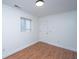 Finished basement area featuring wood floors, neutral walls, and a bright window and door at 338 King St # C, Charleston, SC 29401