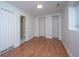 Finished basement area featuring wood floors, neutral walls, and closet space and door to basement bathroom at 338 King St # C, Charleston, SC 29401