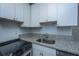 Efficient kitchen features stainless steel appliances, bright white cabinets, granite countertop, and subway tile at 338 King St # C, Charleston, SC 29401