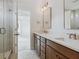 Modern bathroom with double vanity, framed mirrors, white countertop, and glass-enclosed shower at 3802 Grateful Rd, North Charleston, SC 29420