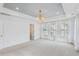 Bedroom featuring white walls, a tray ceiling, lots of windows, and a modern chandelier at 3802 Grateful Rd, North Charleston, SC 29420
