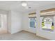 Bright bedroom features a ceiling fan and two windows with views of the outdoors at 3802 Grateful Rd, North Charleston, SC 29420