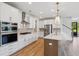 Modern kitchen with white cabinetry, a center island, and stainless steel appliances for a sleek and functional design at 3802 Grateful Rd, North Charleston, SC 29420