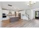 Open-concept kitchen with a center island, stainless steel appliances, and hardwood floors, perfect for entertaining at 3802 Grateful Rd, North Charleston, SC 29420