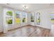 Bright living room featuring hardwood floors, large windows, and sheer curtains, filled with natural light at 3802 Grateful Rd, North Charleston, SC 29420