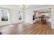 Open-concept living space flows into kitchen with wood floors and lots of natural light at 3802 Grateful Rd, North Charleston, SC 29420