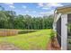 A backyard view of a pond surrounded by a grassy lawn and lush, green trees at 3806 Grateful Rd, North Charleston, SC 29420