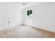 Bright bedroom with neutral carpet, large window, and an attic access door at 3806 Grateful Rd, North Charleston, SC 29420